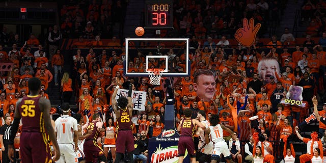 El centro de los Golden Gophers de Minnesota, Daniel Oturu, #25, lanza un tiro libre con la Sección de Estudiantes de Illinois Orange Crush con carteles detrás de la canasta durante un partido de baloncesto universitario entre los Golden Gophers de Minnesota y los Illinois Fighting Illini el 30 de enero de 2020 en el State Farm Center. en Champaign, Illinois.