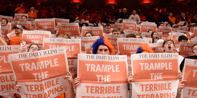 The Orange Krush student section reads The Daily Illini newspaper while introducing themselves to the visiting team before the start of the Big Ten Conference college basketball game between the Maryland Terrapins and the Illinois Fighting Illini on February 7, 2020 at the State Farm Center in Champaign.  , Ill. 
