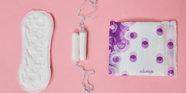 Tampons, a panty liner and a sanitary napkin from different manufacturers are on one table.