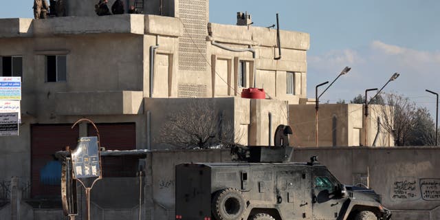 FILE PHOTO: Members of the Syrian Democratic Forces (SDF) line up around the Ghwayran prison, which holds ISIS detainees, in the northeastern city of Hasakeh, Syria on January 25, 2022.