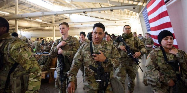 Soldiers with the 82nd Airborne division listen to instructions before deploying to Poland on Feb.  14, 2022 at Fort Bragg, Fayetteville, North Carolina ahead of Russia's invasion of Ukraine.