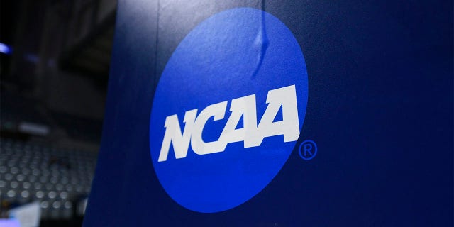 A NCAA logo is displayed on the goal post before the Division III National Championship basketball game between the Randolph-Macon Yellow Jackets and the Elmhurst Bluejays on March 19, 2022, at the Allen County War Memorial Coliseum in Fort Wayne, Indiana. 