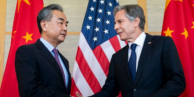 Secretary of State Antony Blinken seen shaking hands with China's Foreign Minister Wang Yi in Bali on July 9, 2022. On Saturday, the two met in Munich for the first time since the Chinese spy balloon controversy. 