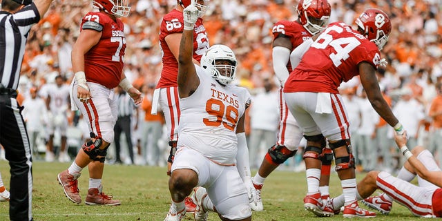 Texas Longhorns defensive lineman Keondre Coburn (99) points to the sky after sacking Oklahoma Sooners quarterback Davis Beville (11) during a game between the Oklahoma Sooners and the Texas Longhorns Oct. 8, 2022, at the Cotton Bowl in Dallas. 