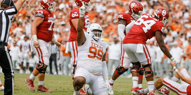 Texas Longhorns defensive lineman Keondre Coburn (99) points to the sky after sacking Oklahoma Sooners quarterback Davis Beville (11) during a game between the Oklahoma Sooners and the Texas Longhorns Oct. 8, 2022, at the Cotton Bowl in Dallas.