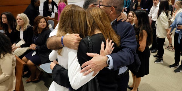 FILE – Linda Beigel Schulman, Michael Schulman, Patricia Padauy Oliver and Fred Guttenberg, family members of the victims, hug inside the courtroom for an expected verdict in the penalty phase of the trial of Marjory Stoneman Douglas High School shooter Nikolas Cruz at the Broward County Courthouse in Fort Lauderdale, Florida on October 13, 2022. - Cruz, who shot and killed 17 people at a Florida high school in 2018, planned and carried out a "systematic massacre," a prosecutor arguing for the death penalty said. 