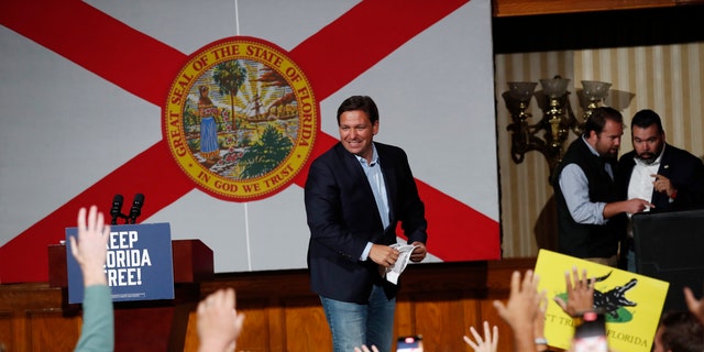Republican Florida Gov. Ron DeSantis tosses hats before giving a campaign speech at a rally for Florida Republicans at the Cheyenne Saloon on November 7, 2022, in Orlando, Florida. 