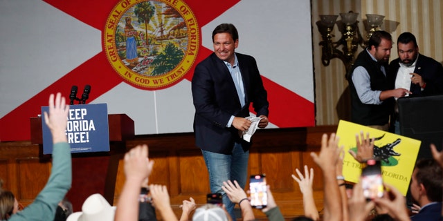 Republican Florida Gov. Ron DeSantis tosses hats before giving a campaign speech at a rally for Florida Republicans at the Cheyenne Saloon on November 7, 2022, in Orlando, Florida.