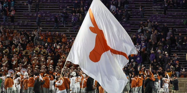 A giant Texas Longhorns flag flies to celebrate a win after a Big 12 college football game between the Texas Longhorns and Kansas State Wildcats Nov. 5, 2022, at Bill Snyder Family Stadium in Manhattan, Kan.