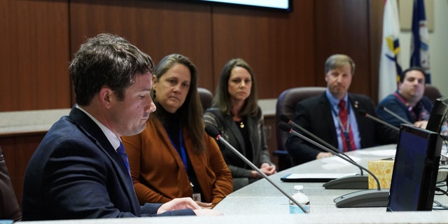 Dr. Daniel Smith, L, takes his place on the board after being appointed interim superintendent of Loudoun County Public Schools at an emergency board meeting at LCPS Administrative Offices on December 8, 2022, in Ashburn, VA.