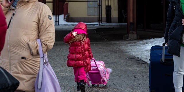 A family arrive at the railway station in Przemysl, Poland from Ukraine on December 20, 2022.