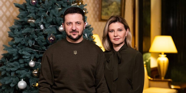 Ukrainian President Volodymyr Zelensky (L) and his wife Olena Zelenska address the Ukrainian people on New Year's Eve in Kyiv, Ukraine, January 1, 2023. 