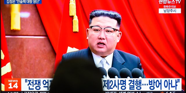 A TV screen shows footage of North Korean leader Kim Jong-un during a news program at the Yongsan Railway Station in Seoul. 