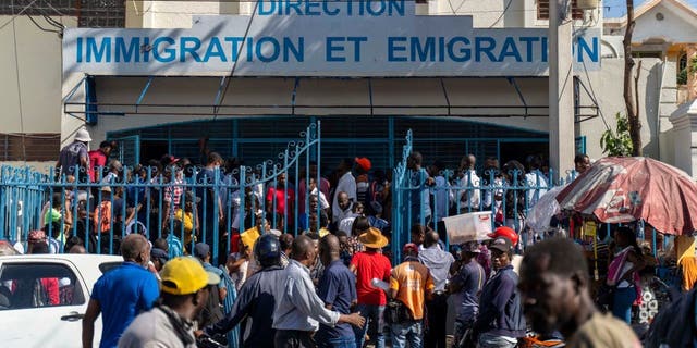 Haitians wait outside an immigration office to apply for a passport in Port-au-Prince on Jan. 10, 2023. 