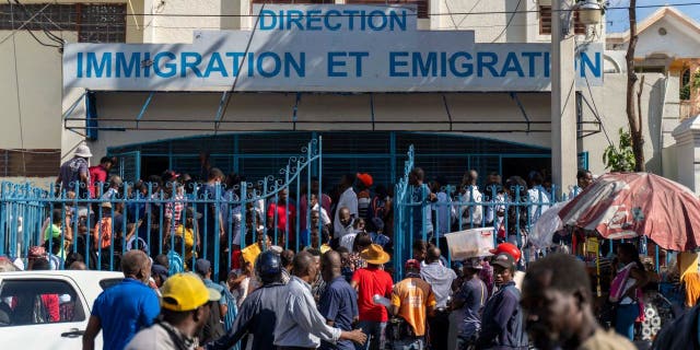 Haitians wait outside an immigration office to apply for a passport in Port-au-Prince on Jan. 10, 2023. 