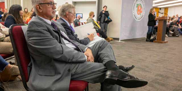 OUSD interim superintendent Edward Velasquez, left, listens to public comments during the Orange Unified School District meeting in Orange on Thursday, January 19, 2023.