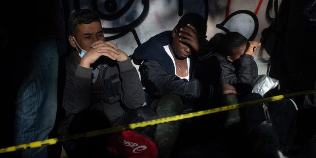 Migrants from Venezuela, Cuba, Haiti and Afghanistan wait in line outside at the Mexican Commission for Refugee Assistance in Mexico City Jan. 24, 2023. 