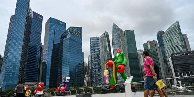 People walk along the promenade at Marina Bay in Singapore on February 1, 2023.