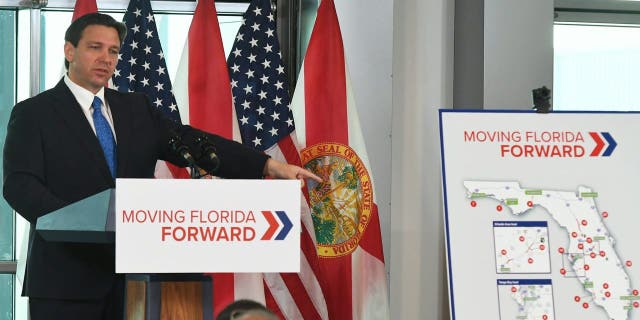 Florida Gov. Ron DeSantis holds a press conference to announce the Moving Florida Forward initiative at the SunTrax Test Facility in Auburndale, Florida.