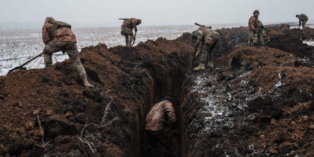 Ukrainian servicemen dig a trench near Bakhmut on Feb. 1, 2023.