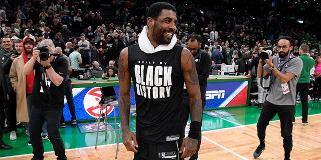 Kyrie Irving #11 of the Brooklyn Nets smiles after the game against the Boston Celtics on February 1, 2023 at TD Garden in Boston, Massachusetts. 