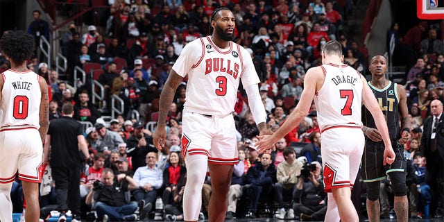 Andre Drummond (3) of the Chicago Bulls high-fives Goran Dragic (7) during a game against the Indiana Pacers on February 2, 2023 at the United Center in Chicago. 