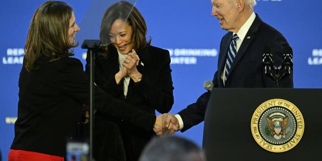 US Vice President Kamala Harris (C), Jana Curtis (L), Founder of Get the Lead Out Riverwards and US President Joe Biden look on at Belmont Water Treatment Center in Philadelphia, Pennsylvania, on February 3, 2023. 