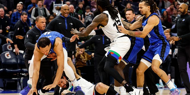 Jalen Suggs #4 of the Orlando Magic (L) gets into a scrum with Austin Rivers #25 of the Minnesota Timberwolves in the third quarter of the game at Target Center on February 03, 2023 in Minneapolis, Minnesota. Suggs and Rivers were ejected from the game. 