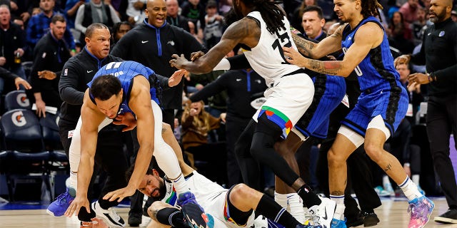 Jalen Suggs #4 of the Orlando Magic (L) gets into a scrum with Austin Rivers #25 of the Minnesota Timberwolves in the third quarter of the game at Target Center on February 03, 2023 in Minneapolis, Minnesota. Suggs and Rivers were ejected from the game. 