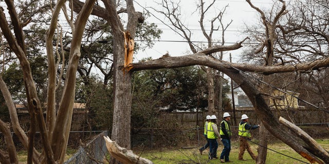 Crews work to restore power to neighborhoods after a winter storm in Austin, Texas, USA on Friday, February 3, 2023.