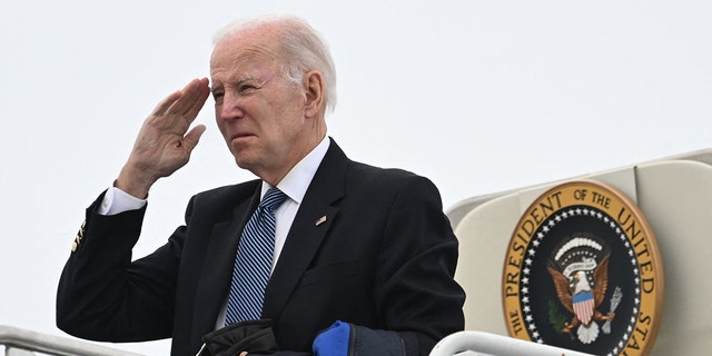 President Biden salutes as he boards Air Force One at Hancock Field Air National Guard Base in Syracuse, New York on Feb. 4, 2023.
