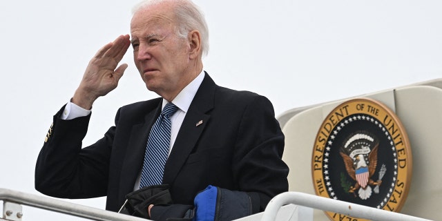 US President Joe Biden salutes as he boards Air Force One at Hancock Field Air National Guard Base in Syracuse, New York, on February 4, 2023. 