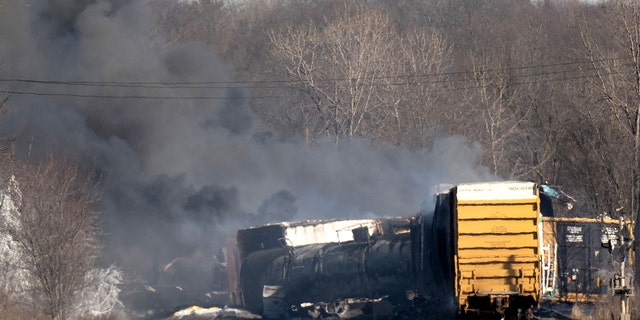 Smoke rises from a derailed cargo train in East Palestine, Ohio, on February 4, 2023. 