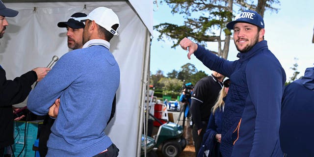 Buffalo Bills quarterback Josh Allen gives a thumbs down while Green Bay Packers quarterback Aaron Rodgers is interviewed during the follow-up to the third round of the AT&T Pebble Beach Pro-Am in Pebble Beach Golf Links on February 5.  2023 in Pebble Beach, California.