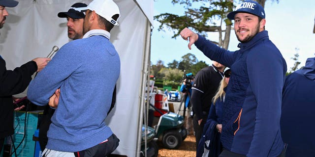 Buffalo Bills quarterback Josh Allen gives a thumbs down while Green Bay Packers quarterback Aaron Rodgers is interviewed during the follow-up to the third round of the AT&T Pebble Beach Pro-Am in Pebble Beach Golf Links on February 5.  2023 in Pebble Beach, California.