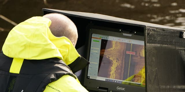 Workers from a private underwater search and recovery company, Specialist Group International, using a 18kHz side-scan sonar on the River Wyre, near St Michael's on Wyre, Lancashire, as they assist in the search for missing woman Nicola Bulley, 45, who was last seen on the morning of Friday January 27, when she was spotted walking her dog on a footpath by the river. Picture date: Monday February 6, 2023. 