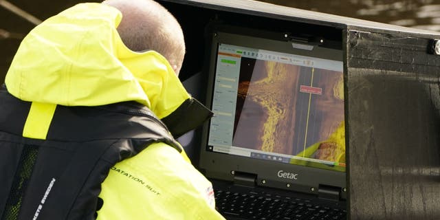 Workers from a private underwater search and recovery company, Specialist Group International, using a 18kHz side-scan sonar on the River Wyre, near St Michael's on Wyre, Lancashire, as they assist in the search for missing woman Nicola Bulley, 45, who was last seen on the morning of Friday January 27, when she was spotted walking her dog on a footpath by the river. Picture date: Monday February 6, 2023.