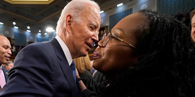 U.S. President Joe Biden hugs Supreme Court Justice Ketanji Brown Jackson before the State of the Union address to a joint session of Congress on February 7, 2023, in the House Chamber of the U.S. Capitol in Washington, DC. 