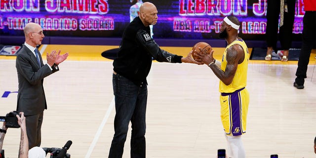 Kareem Abdul-Jabbar, left, passes a ball to LeBron James after James became the NBA's all-time scoring leader, outscoring Abdul-Jabbar by 38,388 points during the third quarter against the Oklahoma City Thunder in Crypto.com Arena on Tuesday, February 7.  , 2023, in Los Angeles. 