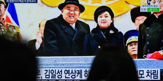 North Korean dictator Kim Jong Un attends a military parade with his daughter.