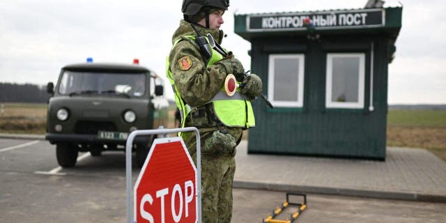 Belarusian border guards check drivers and vehicles near the frontier with Ukraine in the Brest region on Feb. 15, 2023.