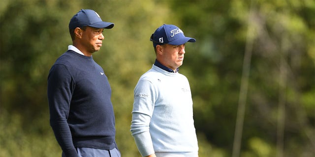 Tiger Woods and Justin Thomas watch the eighth hole during the first round of the Genesis Invitational on February 16, 2023.