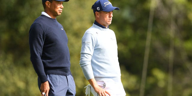 Tiger Woods and Justin Thomas watch the eighth hole during the first round of the Genesis Invitational on February 16, 2023.