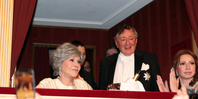 Fonda and Lugner watch from a box seat at the Vienna Opera Ball.