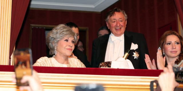 Fonda and Lugner watch from a box seat at the Vienna Opera Ball.