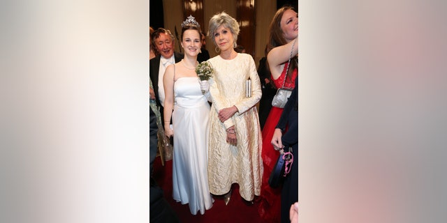 Fonda poses with a debutante during the Vienna Opera Ball.