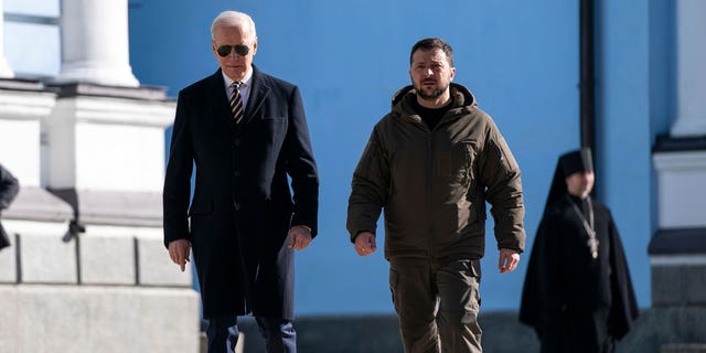 US President Joe Biden (L) walks with Ukrainian President Volodymyr Zelenskyy (R) at St. Michael's Golden-Domed Cathedral during an unannounced visit, in Kyiv on Feb. 20, 2023.