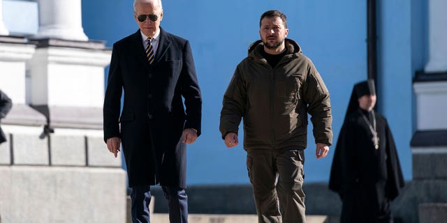 US President Joe Biden (L) walks with Ukrainian President Volodymyr Zelenskyy (R) at St. Michael's Golden-Domed Cathedral during an unannounced visit, in Kyiv on February 20, 2023.