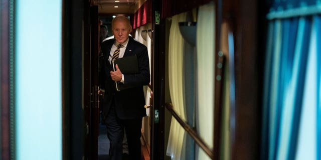 US President Joe Biden walks down a train corridor to his cabin after a surprise visit with Ukrainian President Volodymyr Zelenskyy, in Kyiv on February 20, 2023. 