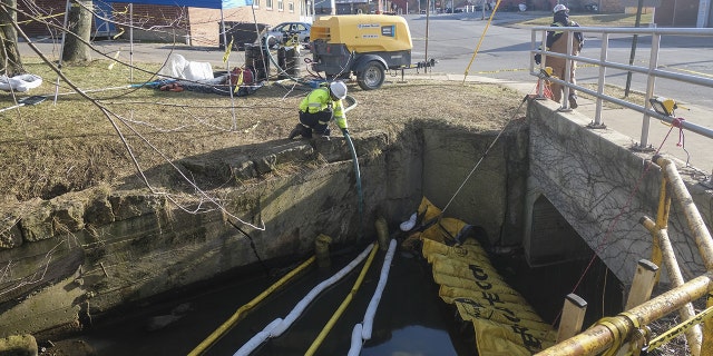 Contractors with Norfolk Southern reroute Sulphur Run creek using pumps upstream in East Palestine, Ohio, US, on Sunday, Feb. 19, 2023. 